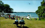 People watch as aircraft take off and land on the water during the Indiana Seaplane Pilots Association Lake James Splash-In on Sunday at Pokagon State Park near Angola.